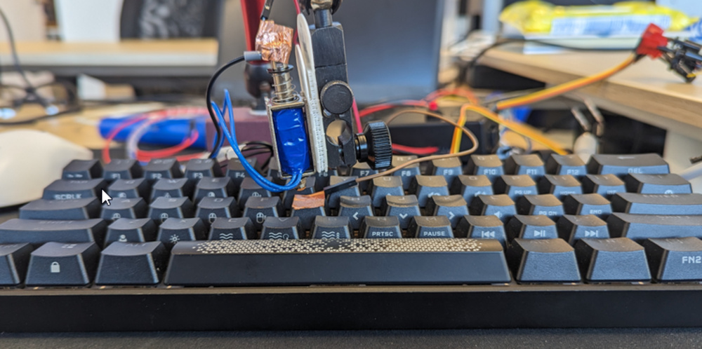 An image of our solenoid rig testing key actuation on the Corsair K65 RGB MINI